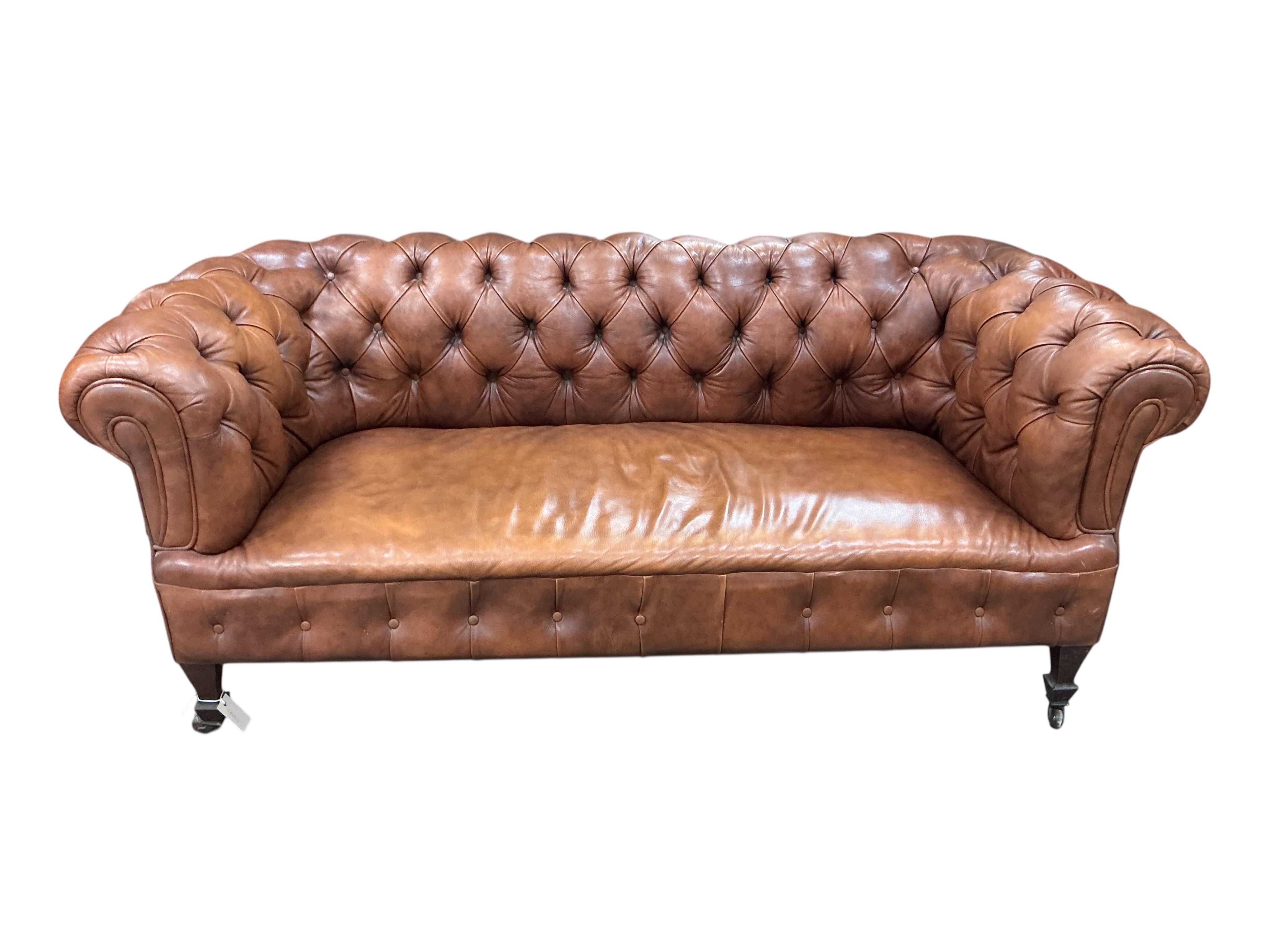 An early 20th century buttoned brown leather Chesterfield settee, width 180cm, depth 78cm, height 71cm
